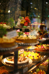 Macaroons and sweet treats piled high in a shop window