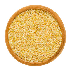 Sweet lupin bean grist in wooden bowl. Milled seeds of the blue lupin, Lupinus angustifolius, also narrowleaf lupin, food crop with edible legume seeds. Macro food photo close up from above over white