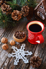 Cup of coffee, coffee beans, pine cones and New Year tree decorations