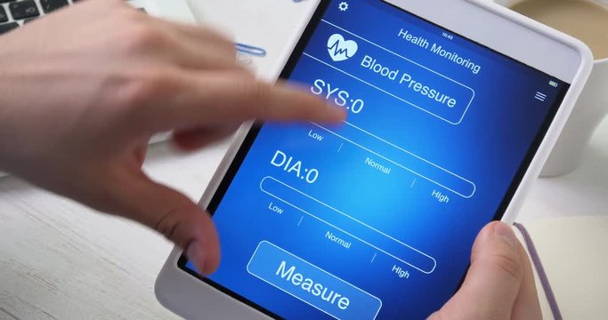 Monitoring blood pressure on health app on the digital tablet