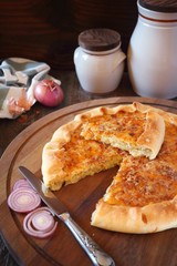 Onion cheese pie on wooden table