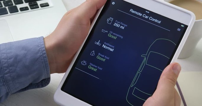 Man checks car information on his digital tablet, the car is in good condition.