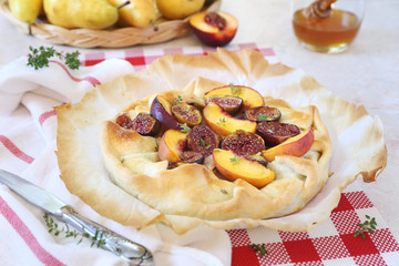 Homemade figs, nectarine and pears tart galette with honey