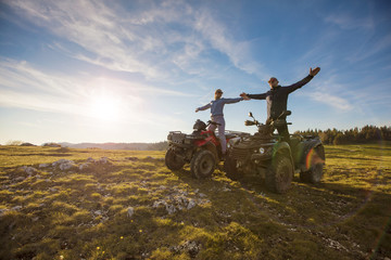 Couple driving off-road with quad bike or ATV © FS-Stock