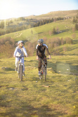 Happy mountainbike couple outdoors have fun together on a summer afternoon