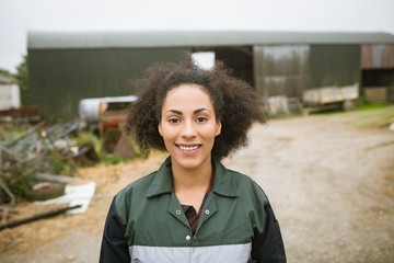 Happy woman standing near barn