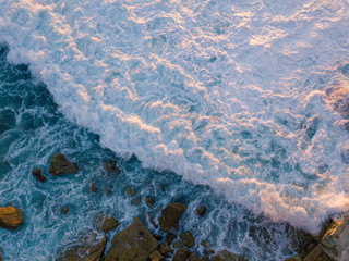 Fototapeta premium White wash of wave aerial view.