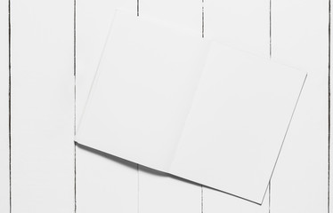 Open  notebook  on white wooden table, top view