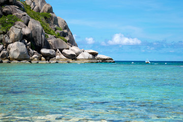 The stone on the beach with blue sea at Koh Chang island in Thailand