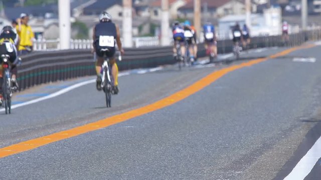 Cycle racing, bicycle race, triathlon race in back shot
