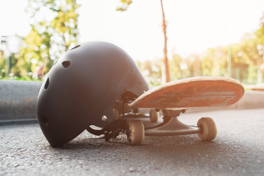 Close Up Skateboard And Helmet, Sport Equipment. Summer Extreme Sport Challenge And Training Background, Protective Sportswear In Competition