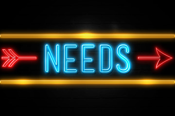 Needs  - fluorescent Neon Sign on brickwall Front view