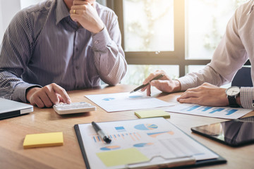 Business team two executive colleagues discussing and analysis working Financial investment on...