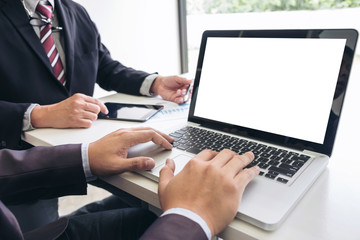Teamwork process, Business team two managers colleagues discussing and analysis new plan financial graph data and marketing documents report on office table with laptop and digital tablet