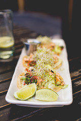 Salmon tacos with sprouts and pico de gallo