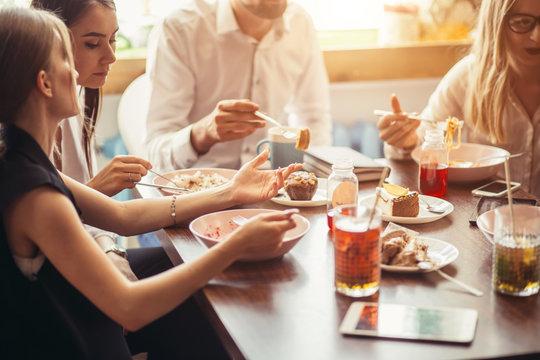 Group of happy business people eating together in restaurant