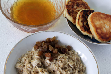 Hot Breakfast oatmeal with raisins and honey.