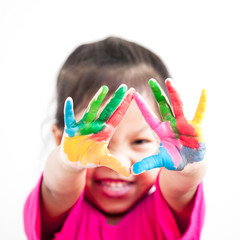 Cute asian child girl with hands painted in colorful paint on white background