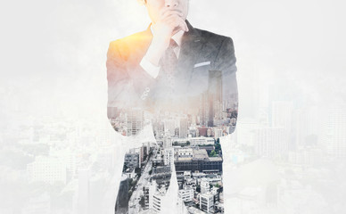 Asia business concept - thoughtful modern office man with dark suit, stand and think the business plan. Double exposure effect with Japan city skyline background. Mix hand drawn sketch illustration