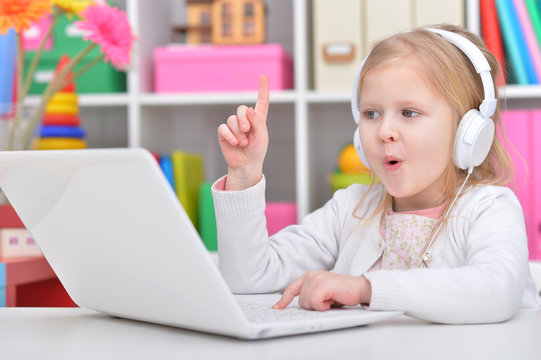 Cute little girl with laptop