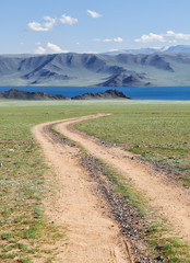 Fototapeta na wymiar Mongolian natural landscapes with country road to the lake Tolbo-Nuur in north Mongolia