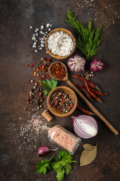 various herbs and spices on dark background.  Cooking concept. Top view.
