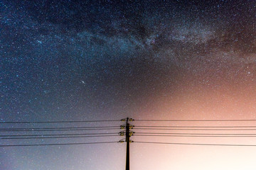 abstract night sky with milky way and star over the silhouette power line