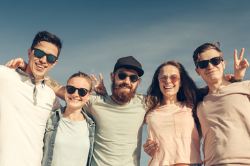 Group of young people enjoy summer party at the beach