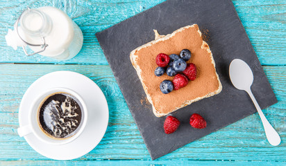 Tiramisu cake with raspberries and blueberries. Homemade tiramisu dessert