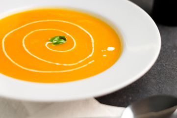 Pumpkin soup with cream swirl. Squash soup is traditionally eaten during the fall season. Pumpkin...