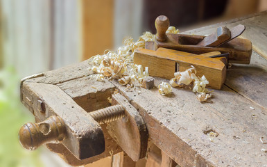 Fragment of old woodworking workbench with two wooden hand planes