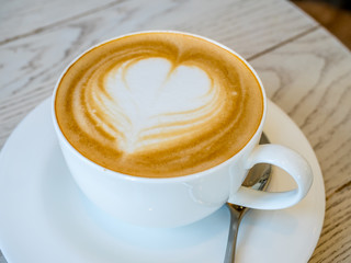 Latte in white cup as breakfast