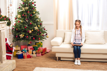 teen with digital tablet at christmastime