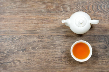 small bowl and teapot on gray wooden table, good morning concept