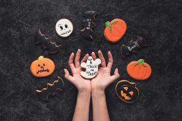 woman holding halloween cookie