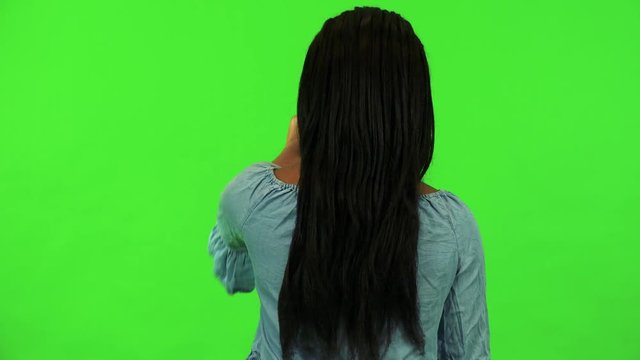 A black woman works on an interactive board - green screen studio