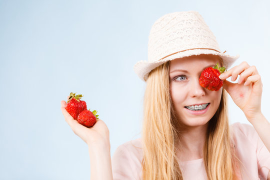 Happy woman holding strawberries