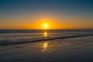 Sunset on the tropical beach. Cuta beach on Bali island. Indonesia