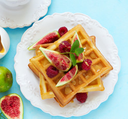 Homemade waffles with caramel sauce, figs and raspberries.