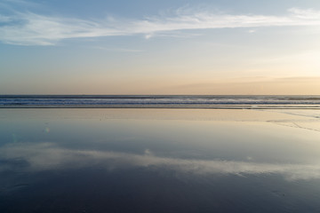 Fototapeta na wymiar Sunset at Cuta Beach, Bali with beautiful mirror reflection