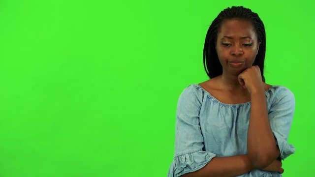 A young black woman is bored - green screen studio