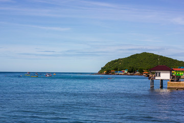 house and boats oo the sae with mount ans sky, texture background
