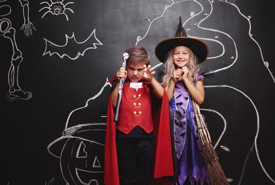 Couple wearing in costume witch and vampire