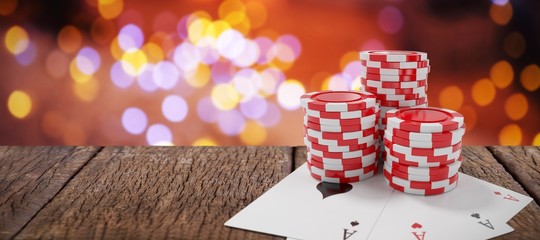 Fototapeta premium Composite image of red casino tokens with playing cards