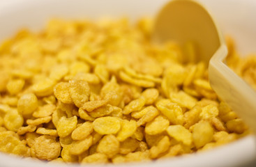 Corn flakes with spoon for breakfast. Selective focus. Macro