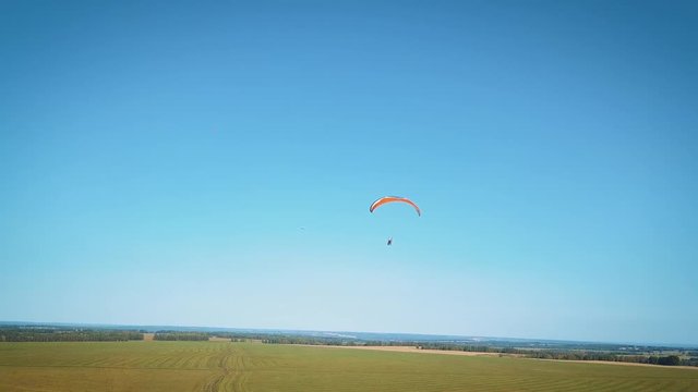 Paraplane, paraglider in the air aerial shot. Extreme life. A man is flying on a paraglider