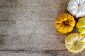 Colorful pumpkin on wood table from top view with copy space.