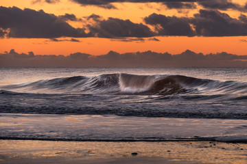 Wave at danish coastline during sunset