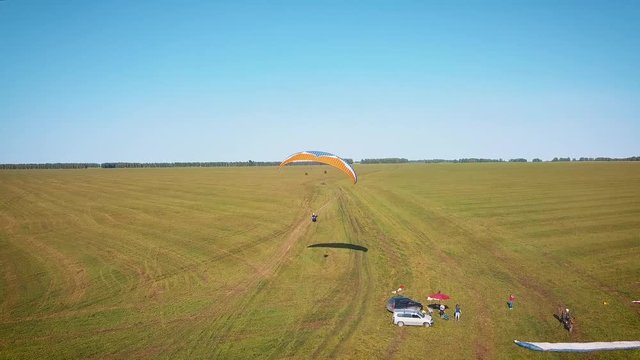 Paraplane, paraglider in the air aerial shot. Extreme life. A man is flying on a paraglider
