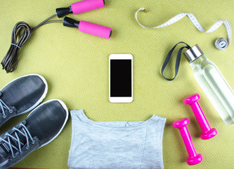 Flat lay shot of sneakers, earphones, phone.